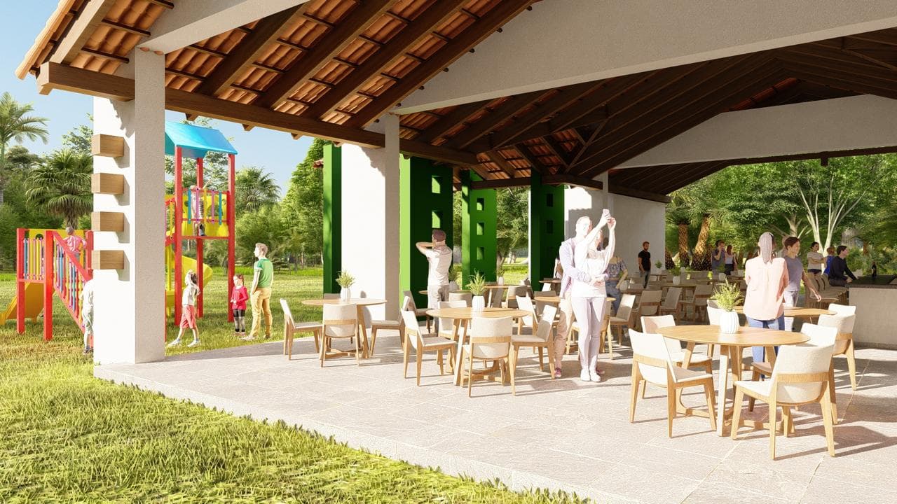 Render del salón techado del club house con mesas, y el parque infantil sobre el césped al lado.