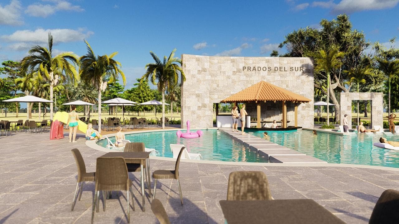 Render de la piscina del club house de Prados del Sur, con el muro de piedra que lleva el nombre del proyecto, un bar bajo techo de teja, sombrillas, tumbonas y un tobogán para los chicos.